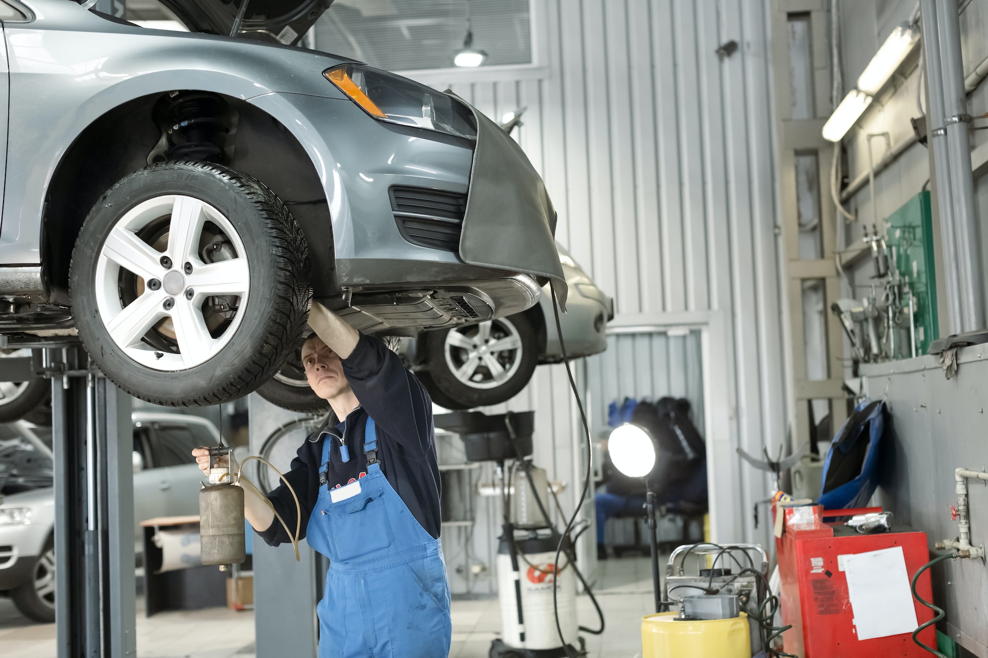 blow-the-air-in-break-system-car-mechanic-is-under-the-car
